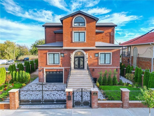 view of front facade with a fenced front yard, french doors, concrete driveway, and brick siding