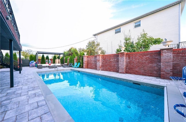 view of pool featuring a fenced in pool, a patio, fence, a pergola, and an outdoor living space