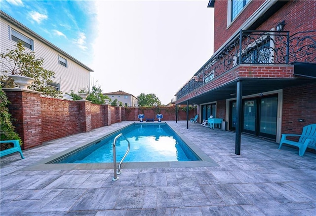 view of swimming pool with a fenced in pool, a fenced backyard, and a patio