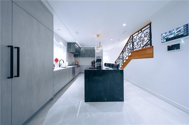 kitchen featuring recessed lighting, a sink, wall chimney range hood, and modern cabinets