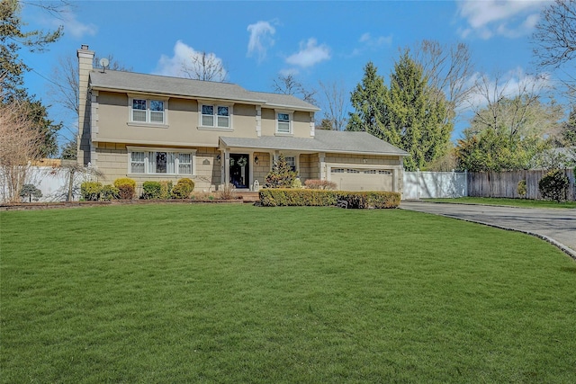 view of front of property featuring driveway, fence, a front yard, a garage, and a chimney