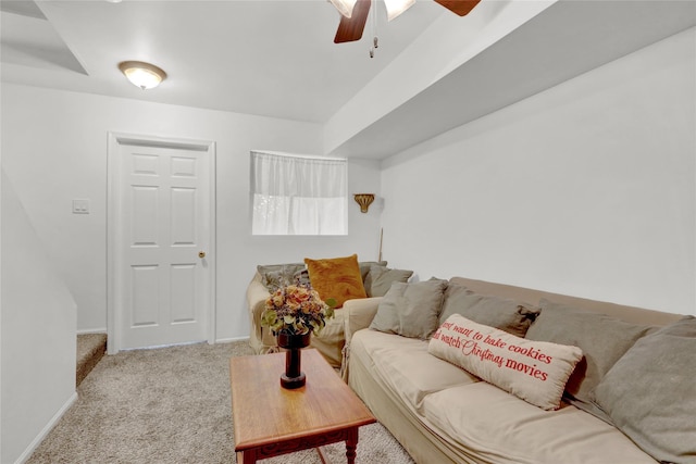 carpeted living room featuring ceiling fan and baseboards