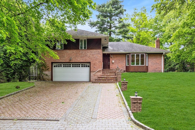 tri-level home with brick siding, a chimney, decorative driveway, and a front lawn