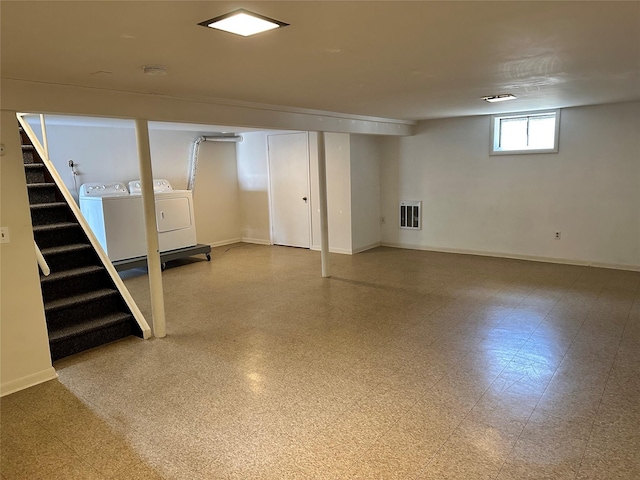 basement featuring stairs, baseboards, separate washer and dryer, and tile patterned floors