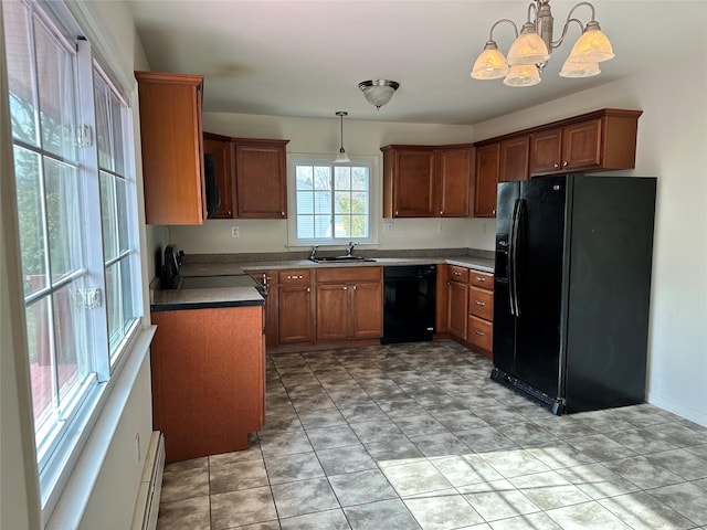 kitchen with hanging light fixtures, black appliances, brown cabinetry, and a sink