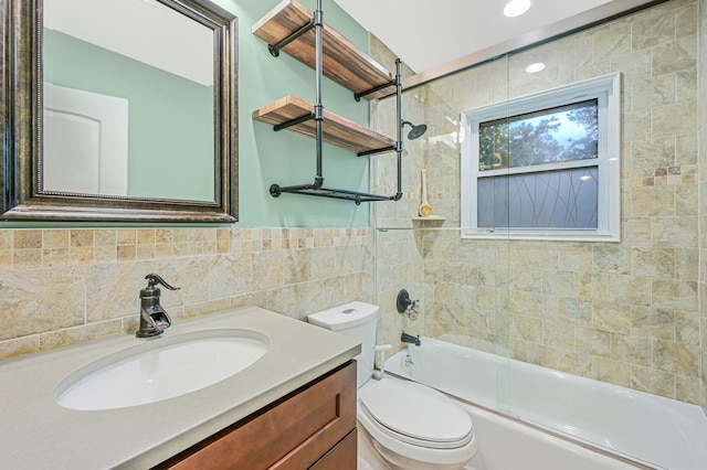 full bathroom featuring shower / bath combination, toilet, tile walls, and vanity