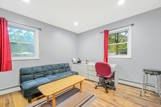 office space featuring a baseboard radiator, wood finished floors, and recessed lighting