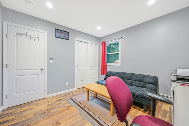 living room with recessed lighting, light wood-style flooring, and baseboards