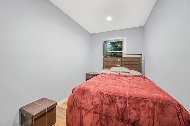 bedroom with light wood-style floors and baseboards