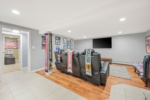 exercise area featuring baseboards, a baseboard heating unit, light wood-style flooring, and recessed lighting