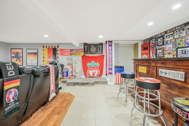 game room featuring recessed lighting, beamed ceiling, a dry bar, and tile patterned floors