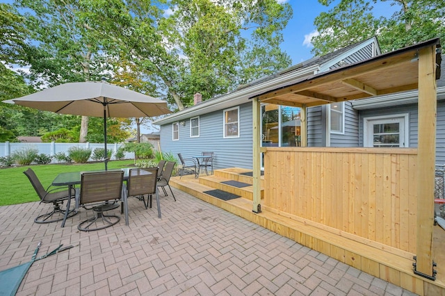 view of patio featuring outdoor dining space and fence