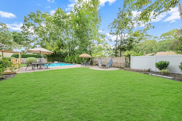 view of yard featuring a patio area, a fenced backyard, a fire pit, and a fenced in pool