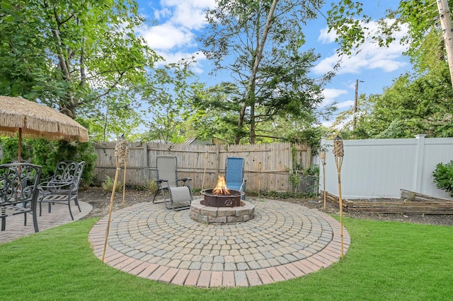 view of patio / terrace with an outdoor fire pit and a fenced backyard