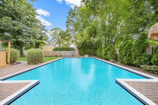 view of pool with a fenced in pool, fence, and a patio