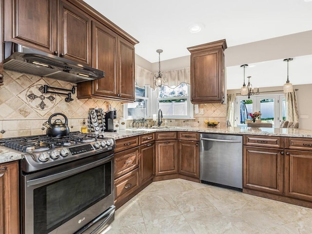16 Joan Dr, Yonkers, NY 10704 - kitchen featuring stainless steel appliances, under cabinet range hood, a sink, a chandelier, and backsplash