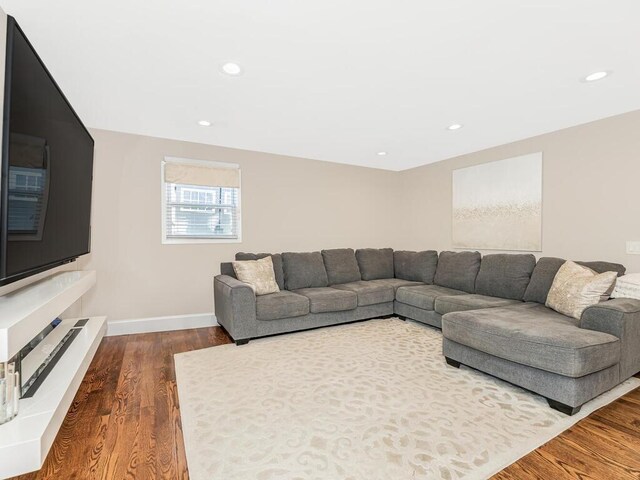 16 Joan Dr, Yonkers, NY 10704 - living area featuring dark wood-style floors, recessed lighting, and baseboards