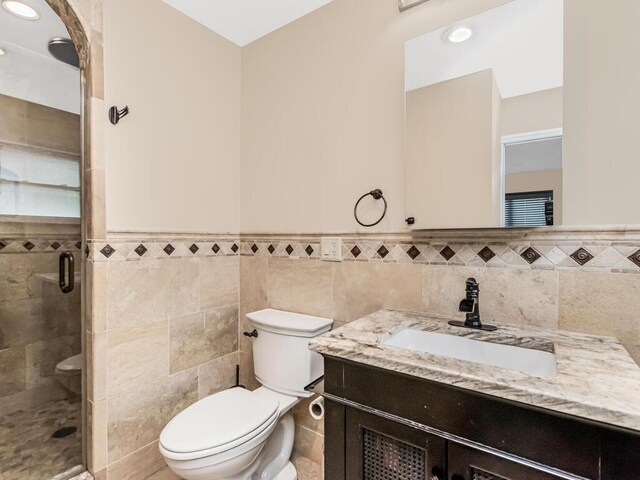 16 Joan Dr, Yonkers, NY 10704 - full bath with toilet, wainscoting, vanity, tile walls, and a stall shower