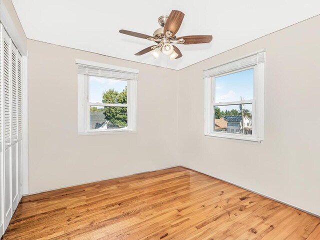 16 Joan Dr, Yonkers, NY 10704 - unfurnished bedroom featuring a closet, wood finished floors, and a ceiling fan