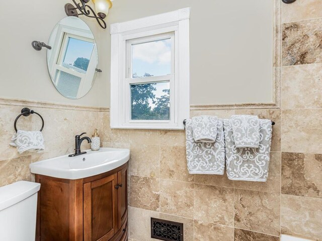 16 Joan Dr, Yonkers, NY 10704 - bathroom featuring vanity, toilet, and a wainscoted wall