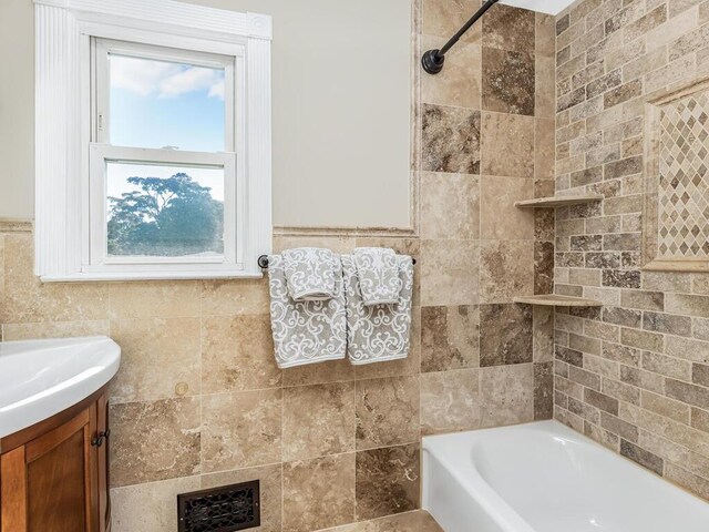 16 Joan Dr, Yonkers, NY 10704 - bathroom featuring tile walls, vanity, and bathtub / shower combination