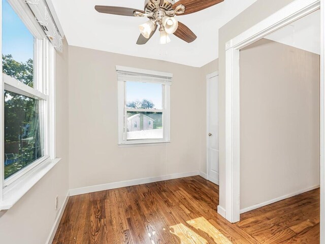 16 Joan Dr, Yonkers, NY 10704 - unfurnished bedroom with multiple windows, wood finished floors, and baseboards