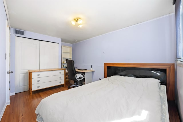 bedroom featuring wood finished floors and visible vents