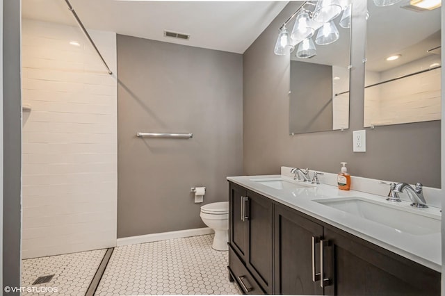 full bath with toilet, a sink, visible vents, and a tile shower