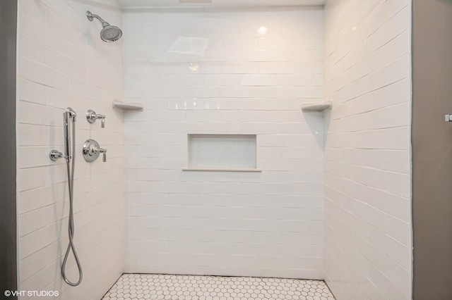 bathroom with a tile shower