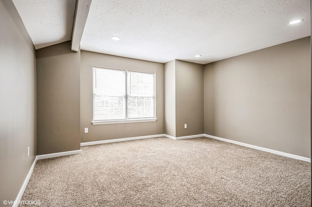 carpeted empty room featuring recessed lighting, a textured ceiling, and baseboards