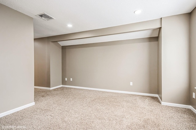 finished basement with carpet floors, recessed lighting, visible vents, and baseboards