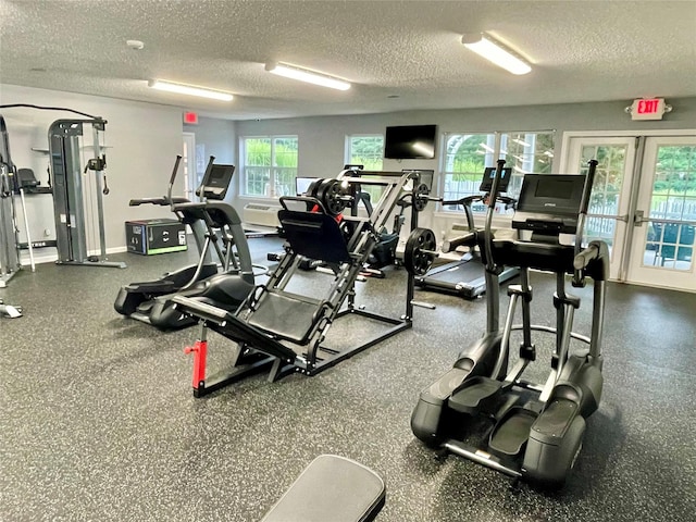 workout area featuring a textured ceiling, french doors, and baseboards