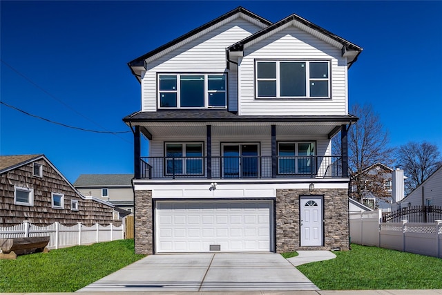 view of front of house featuring fence, a garage, stone siding, driveway, and a front lawn