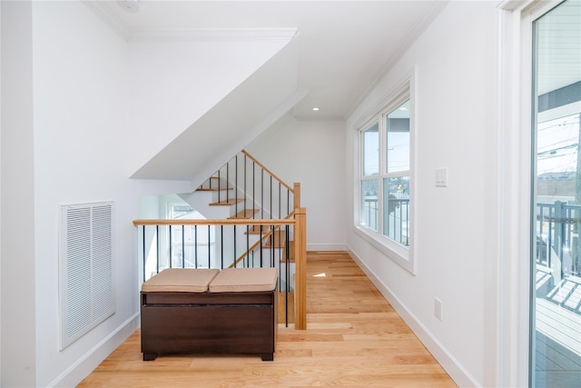 corridor with plenty of natural light, visible vents, light wood-style flooring, and baseboards