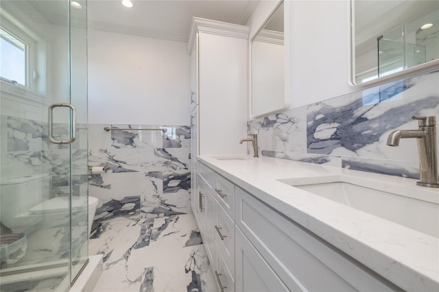 bathroom with marble finish floor, a marble finish shower, and a sink