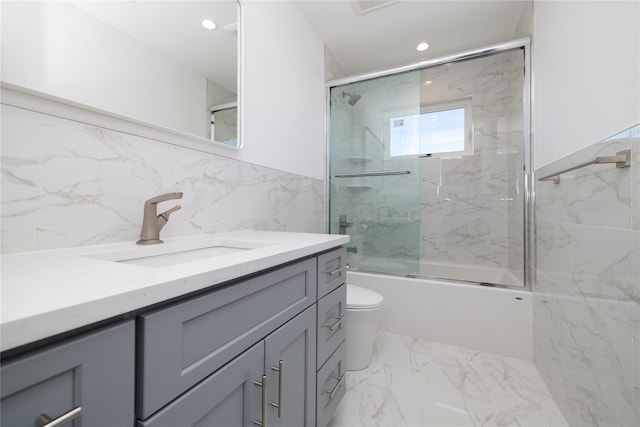 full bath featuring recessed lighting, marble finish floor, tile walls, and vanity