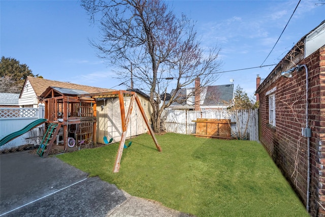 view of yard with a playground and a fenced backyard