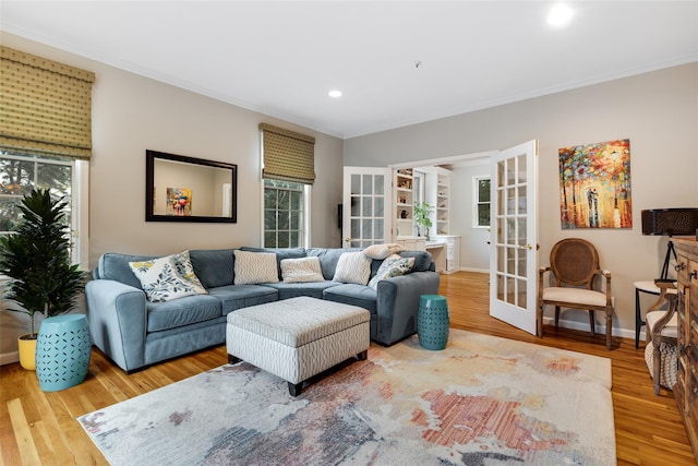 living room featuring ornamental molding, french doors, and wood finished floors