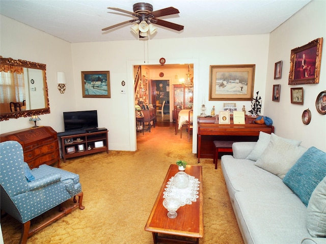 living area with a ceiling fan and light carpet