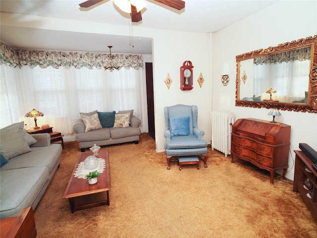 living room featuring carpet, ceiling fan, and radiator heating unit