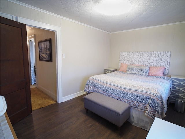 bedroom featuring ornamental molding, wood finished floors, and baseboards