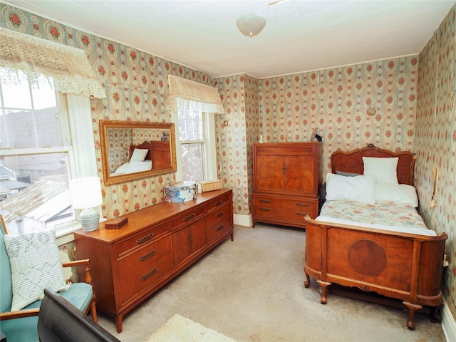 bedroom featuring light colored carpet and wallpapered walls