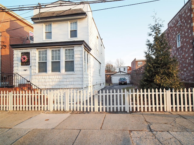 traditional home featuring a fenced front yard and entry steps