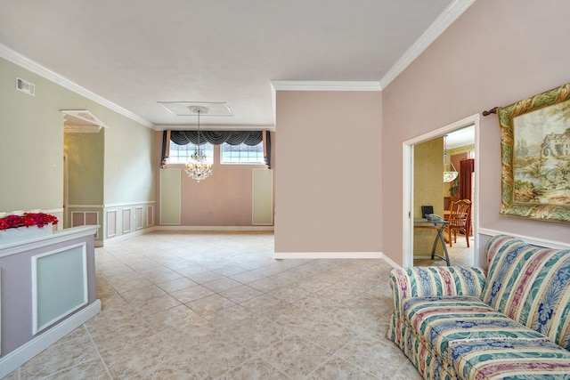 living room with a wainscoted wall, ornamental molding, visible vents, and a decorative wall