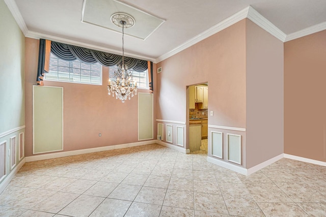 interior space featuring wainscoting, an inviting chandelier, crown molding, a decorative wall, and light tile patterned flooring