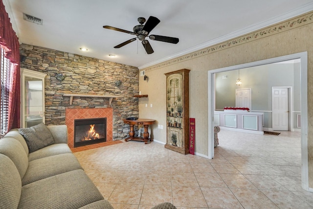 living area featuring a fireplace, light tile patterned floors, visible vents, ornamental molding, and baseboards