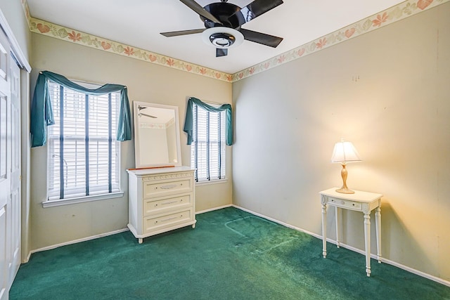 unfurnished bedroom featuring carpet floors, baseboards, and a ceiling fan