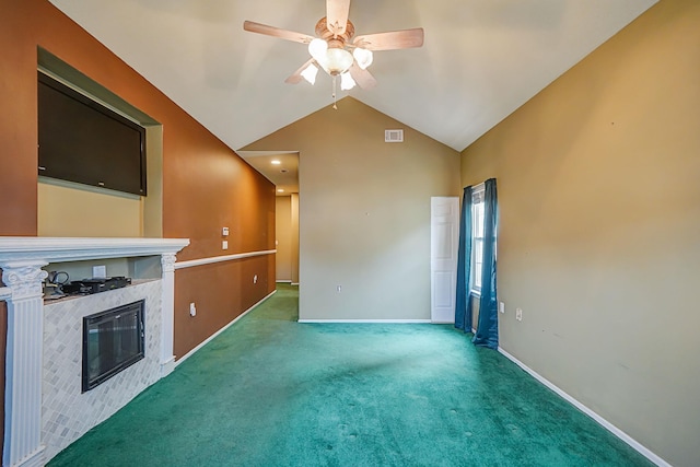 unfurnished living room featuring ceiling fan, a fireplace, carpet flooring, baseboards, and vaulted ceiling