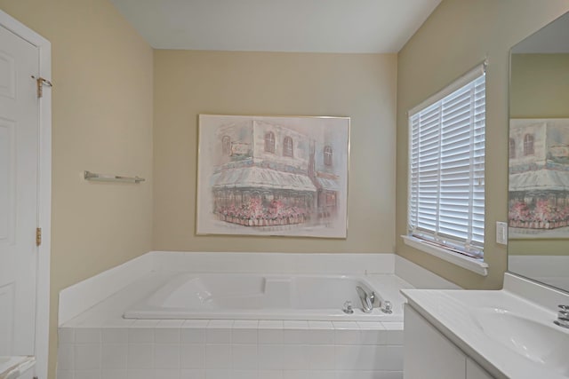 bathroom featuring a garden tub and vanity