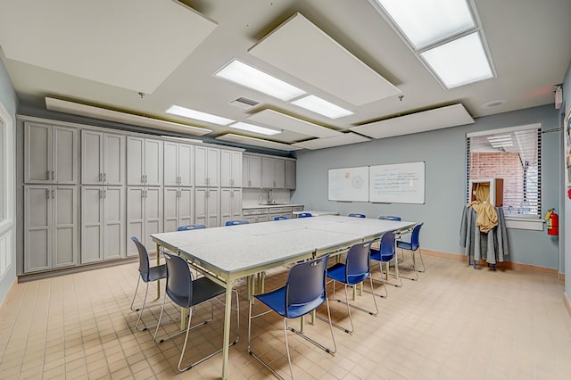 interior space featuring a sink, visible vents, and baseboards